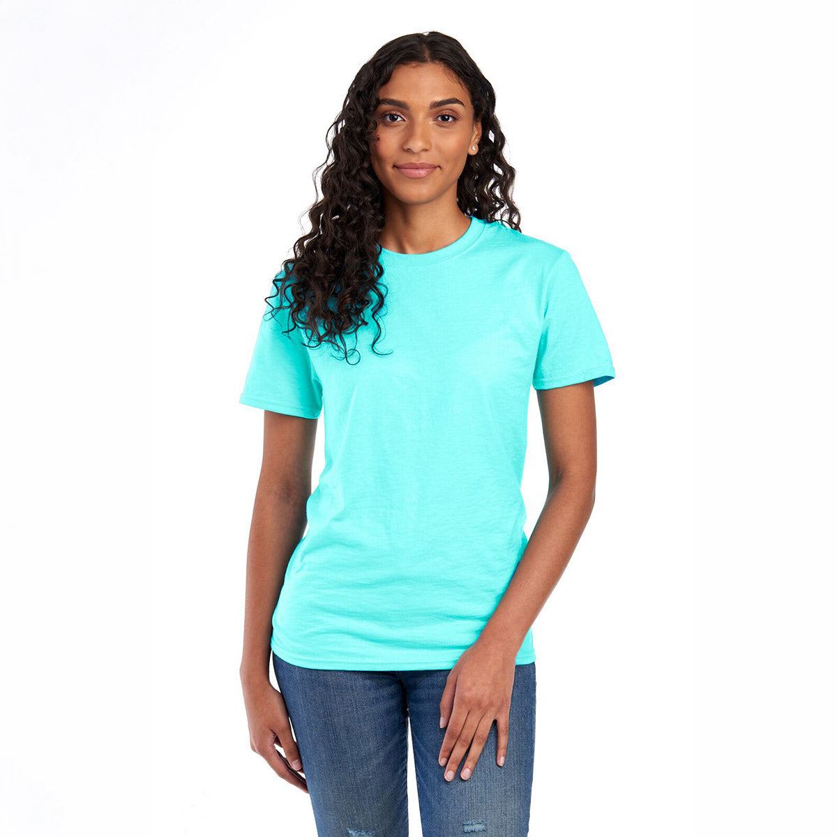 A woman wearing a Scuba Blue Jerzees Premium Blend Combed Ring-Spun Unisex T-Shirt against a white background.