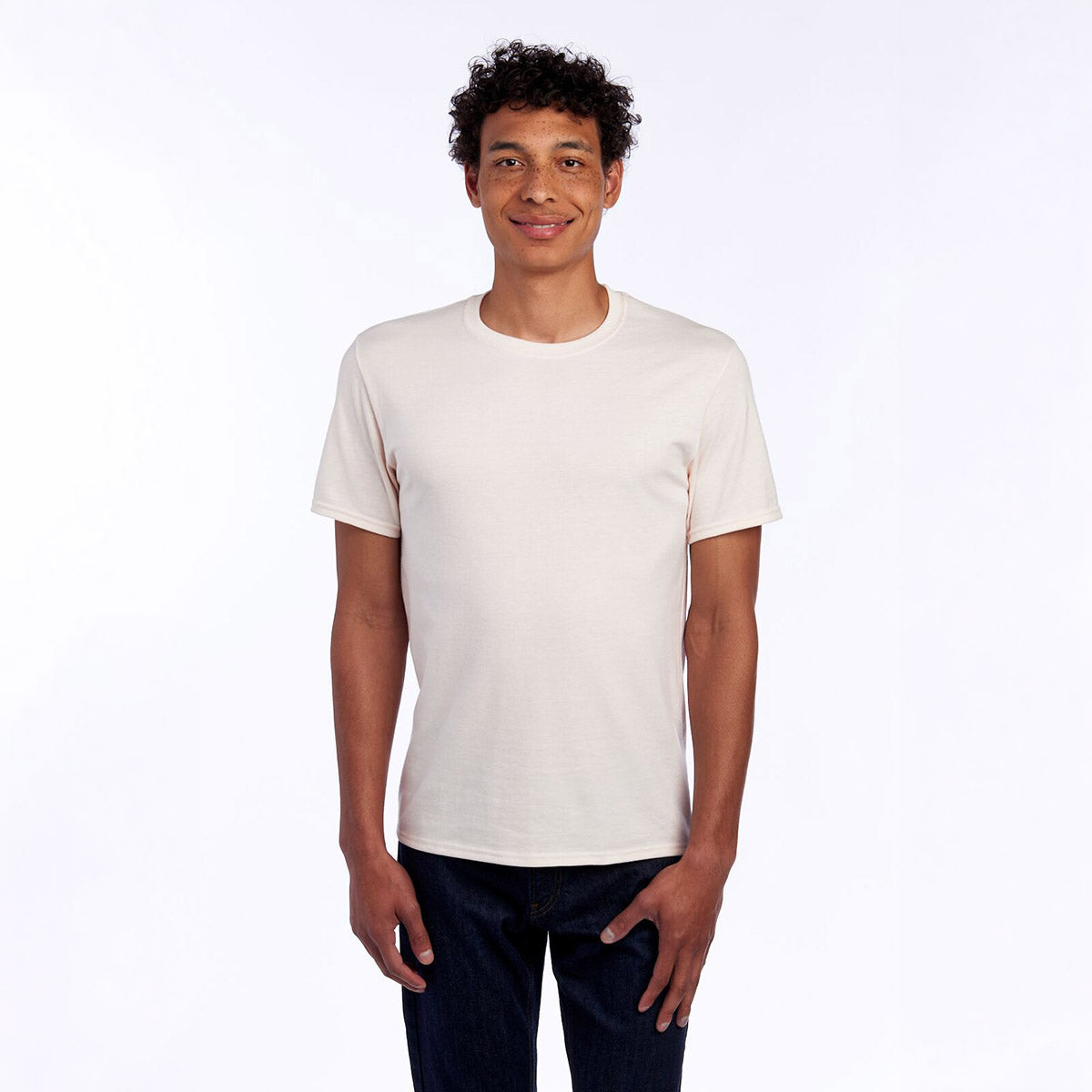 A model wearing a Jerzees Premium Blend Combed Ring-Spun unisex T-shirt in Sweet Cream Heather.