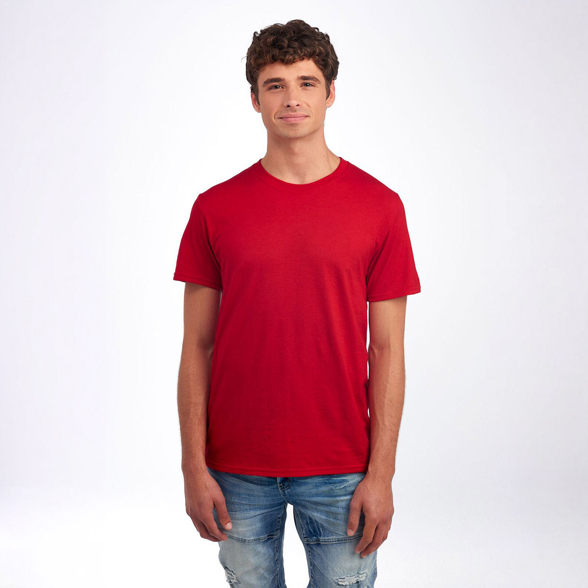 A man wearing a Jerzees Premium Blend Combed Ring-Spun unisex T-shirt in true red against a white background.