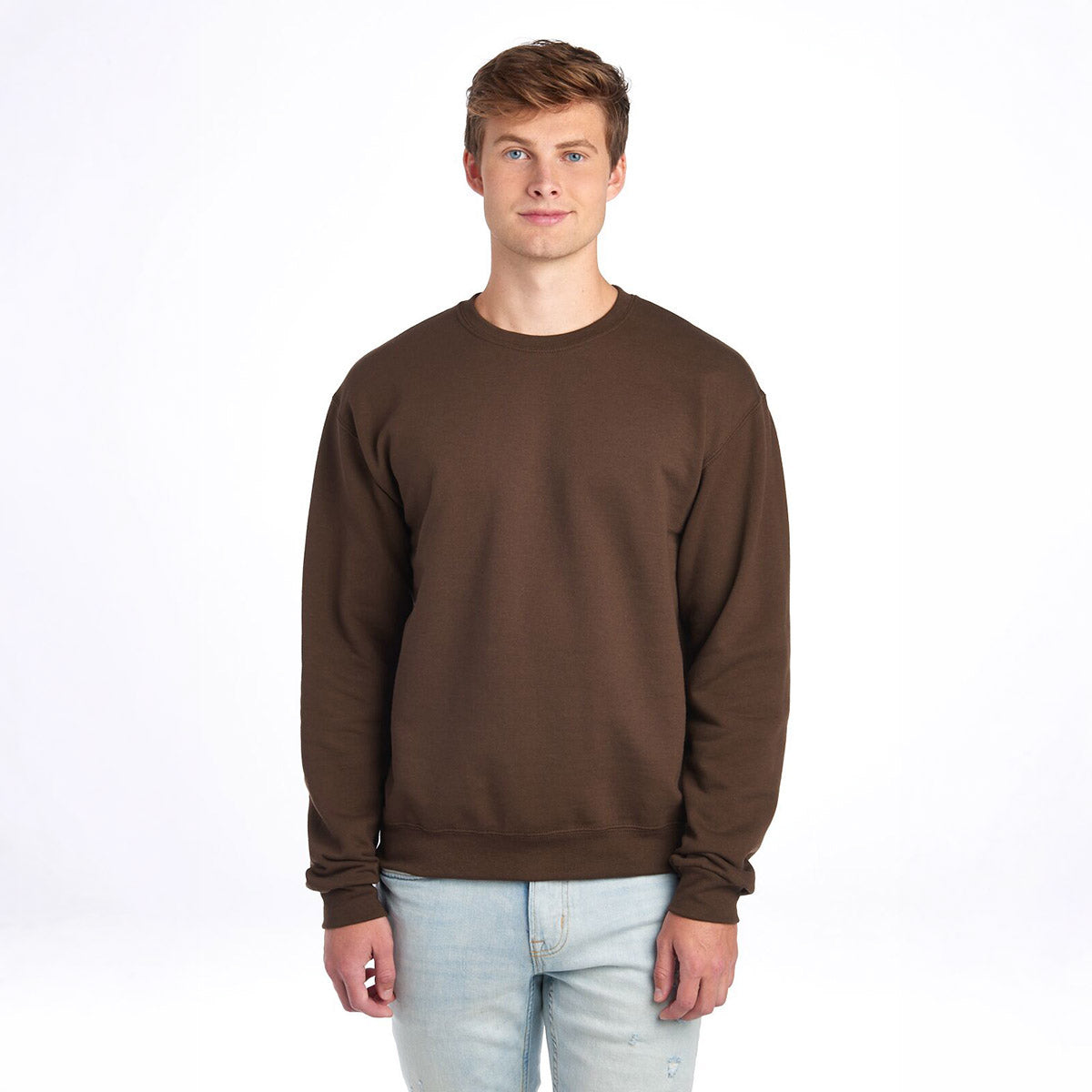 A man modeling a chocolate brown Jerzees NuBlend® Adult Sweatshirt against a plain white background.