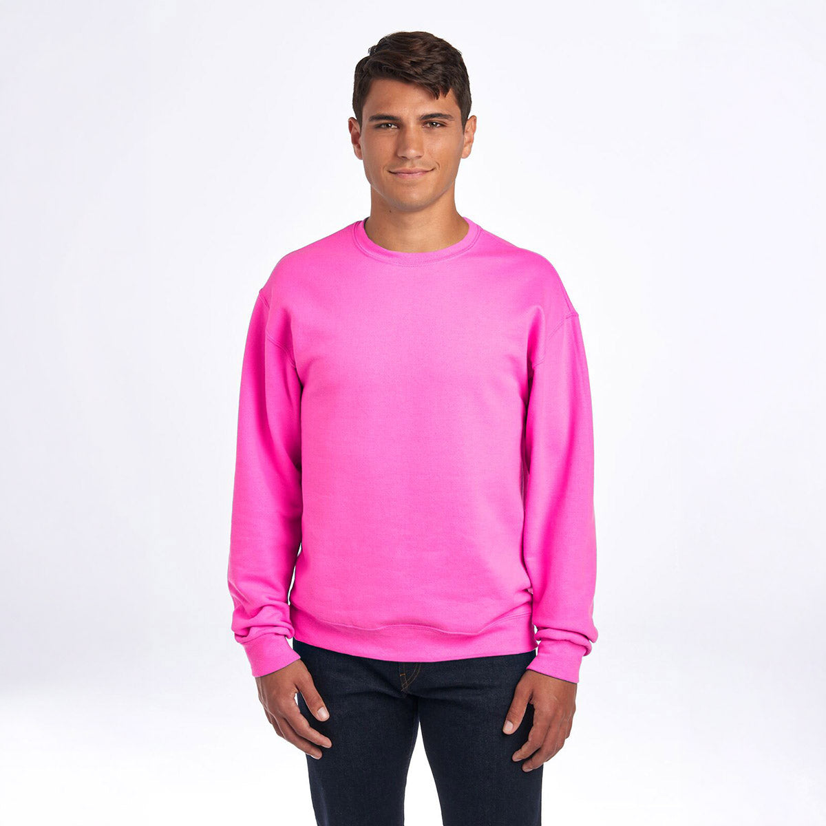 A man wearing a neon pink Jerzees NuBlend Adult Sweatshirt against a white background.