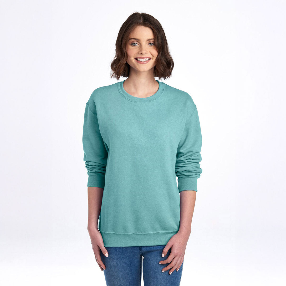 Woman wearing a sage Jerzees NuBlend Adult Sweatshirt with a crew neck and long sleeves.