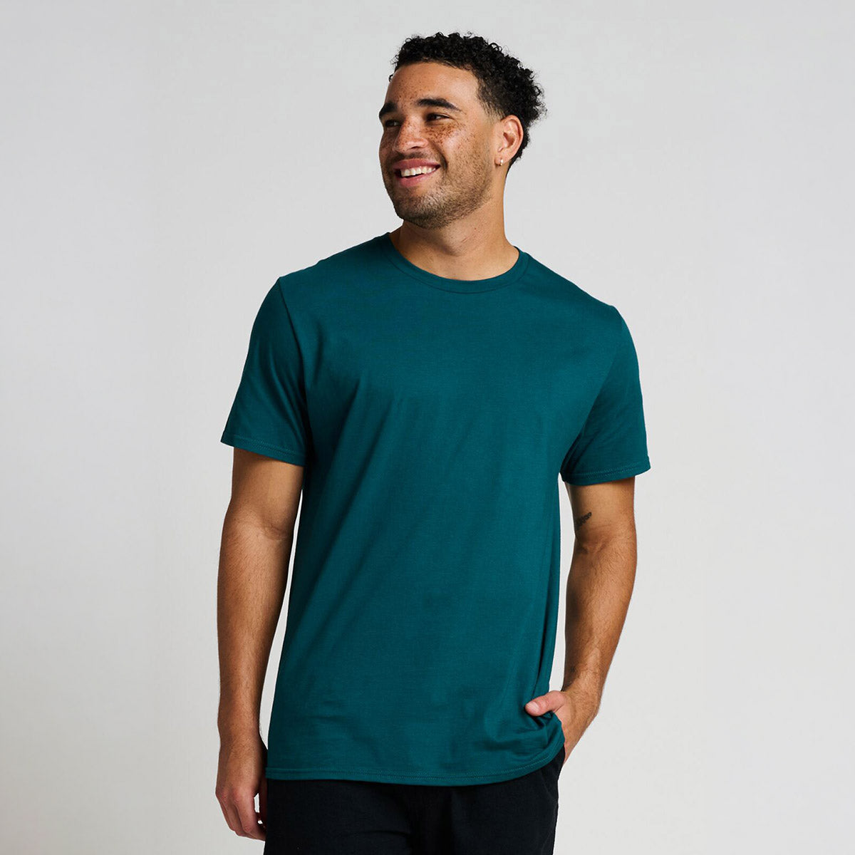 Man wearing a Jerzees Premium Combed Ring-Spun Cotton Unisex T-Shirt in Deep Emerald against a white background.