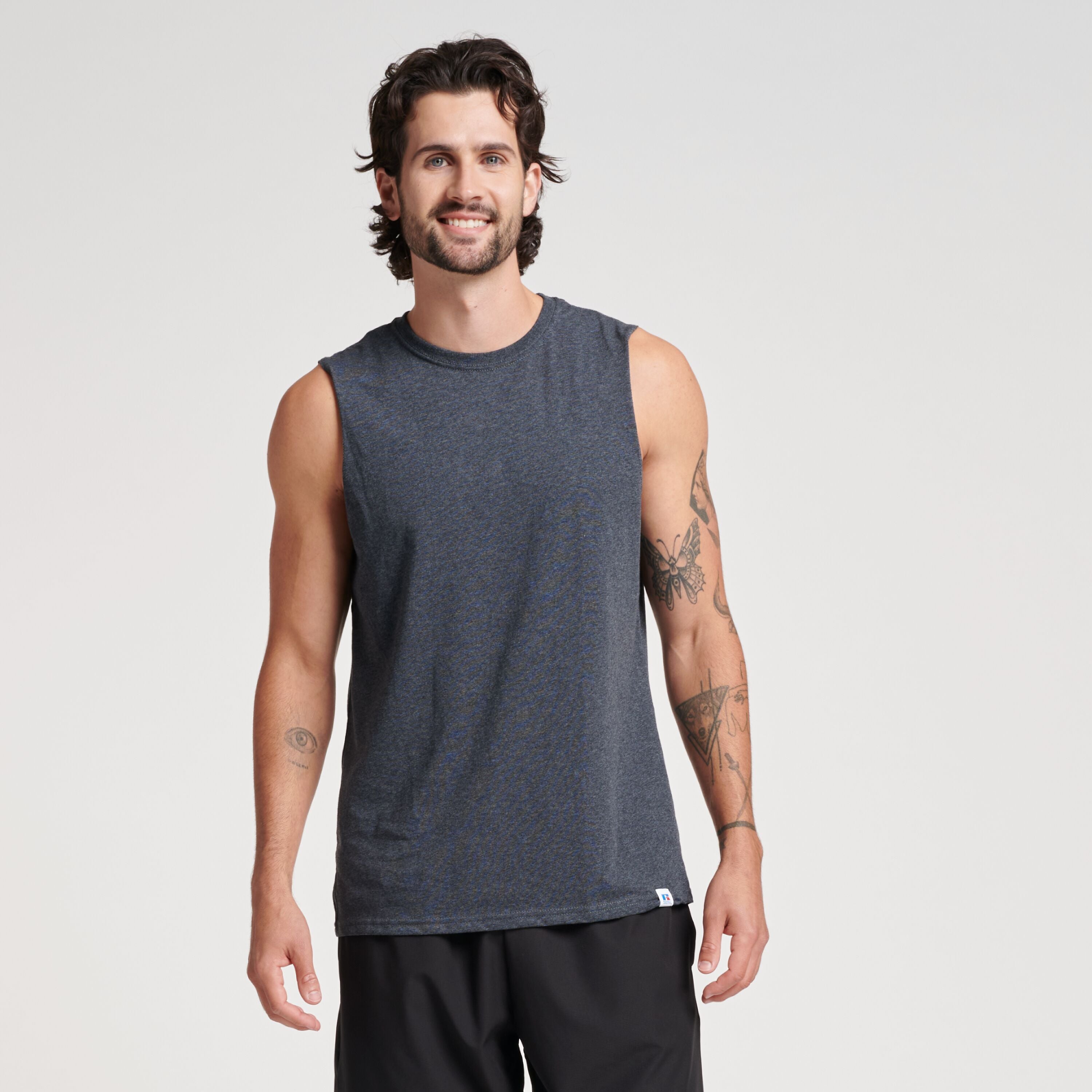 Russell Athletic DRI-POWER® CVC Performance Unisex Muscle T-Shirt in black heather on a smiling male model.