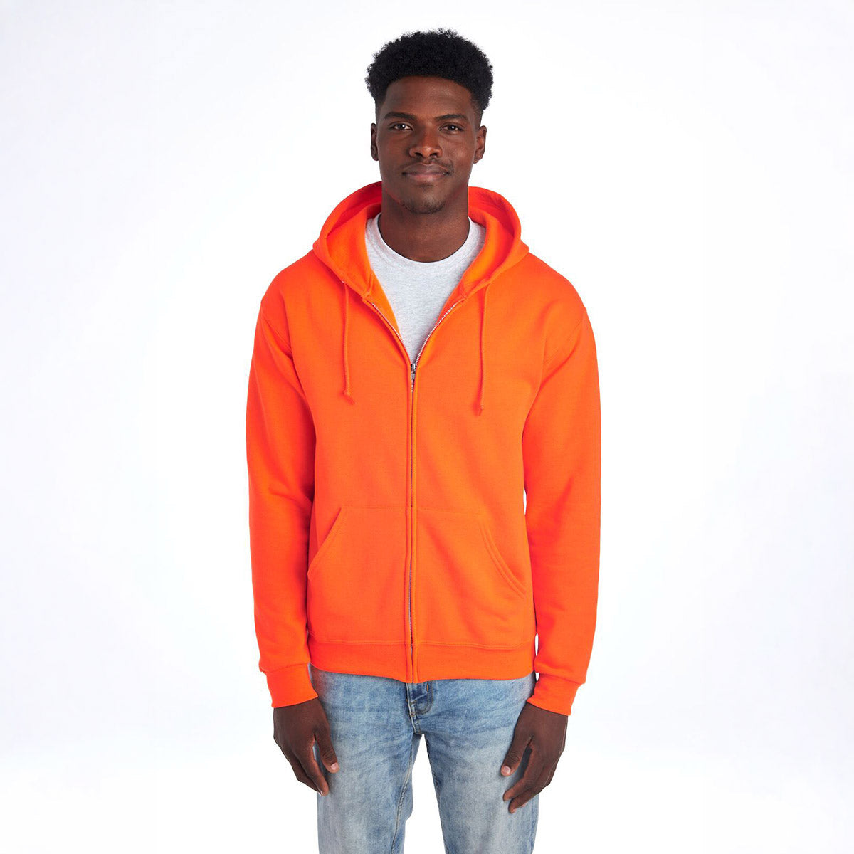 A man wears a Safety Orange Jerzees NuBlend Unisex Full-Zip Hooded Sweatshirt against a white background.