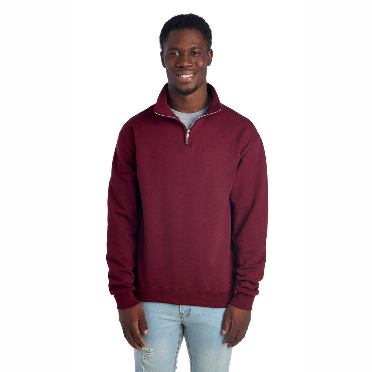 A man wearing a maroon Jerzees NuBlend unisex quarter-zip cadet collar sweatshirt.