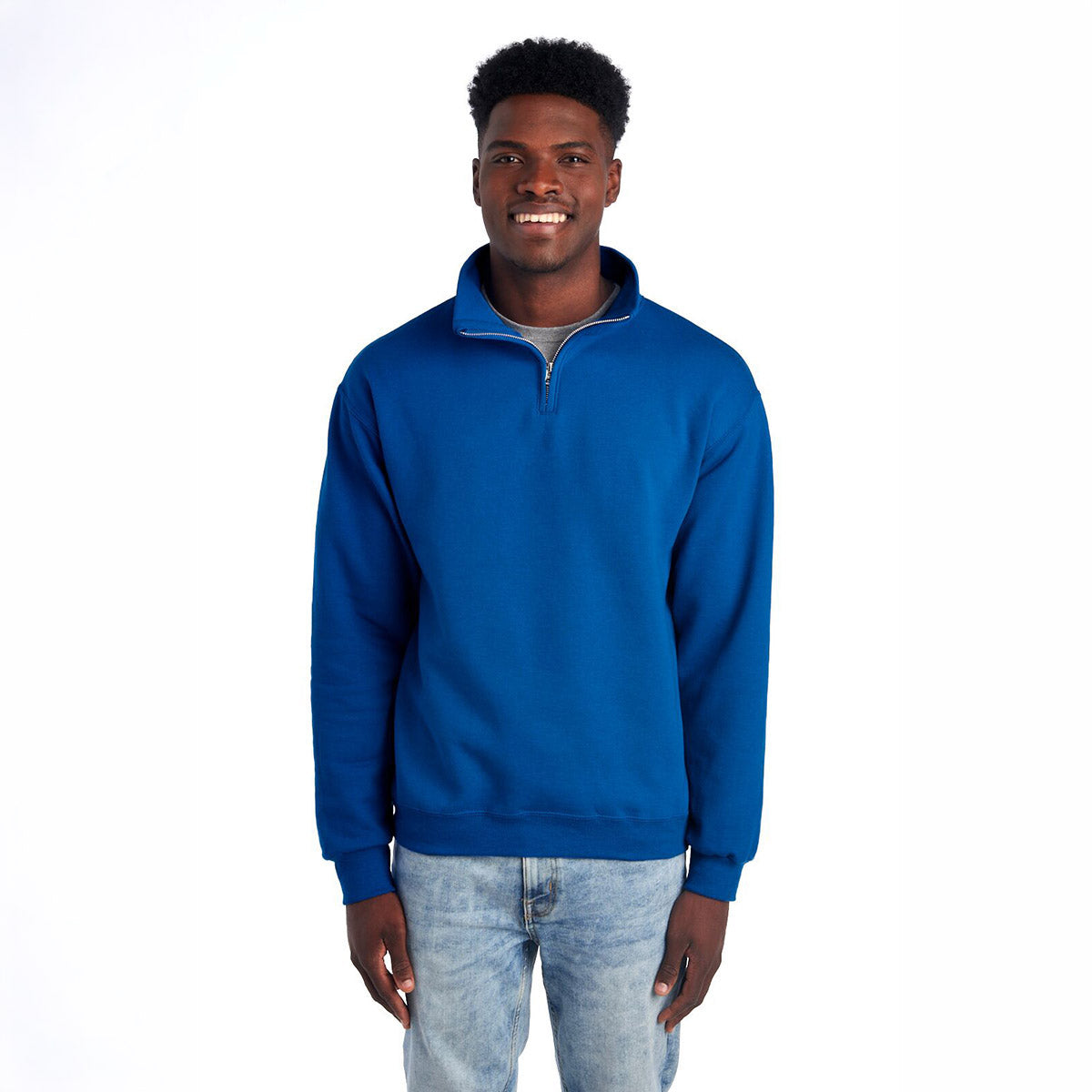 A man smiling while wearing a royal blue Jerzees NuBlend unisex quarter-zip cadet collar sweatshirt.