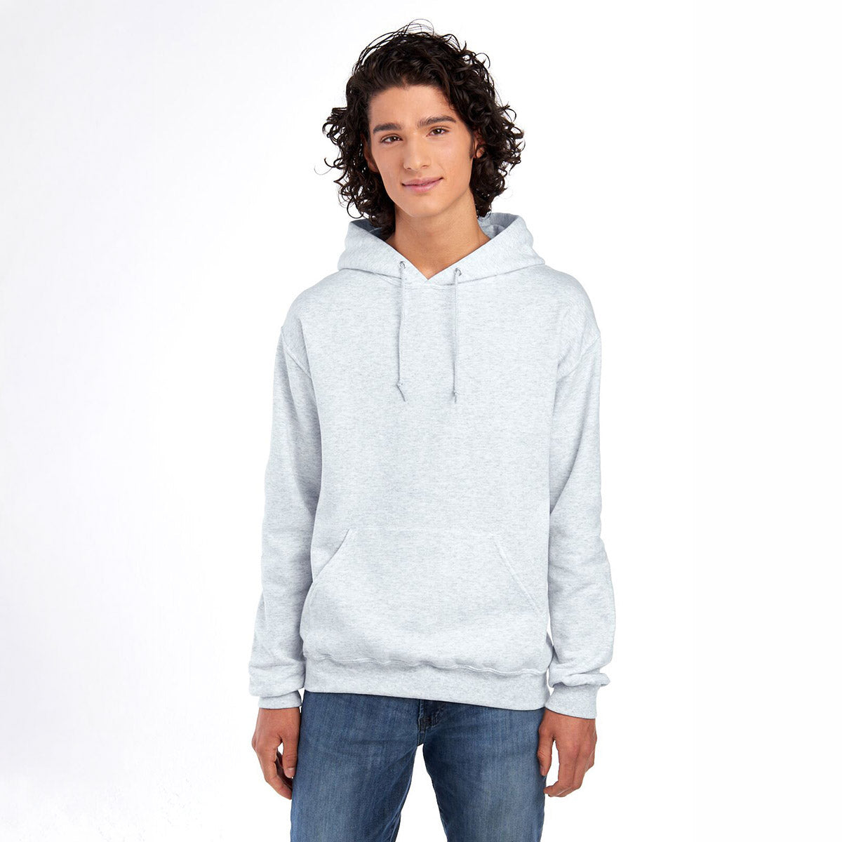 Young man wearing a light ash grey Jerzees NuBlend® Unisex Hooded Sweatshirt against a white background.