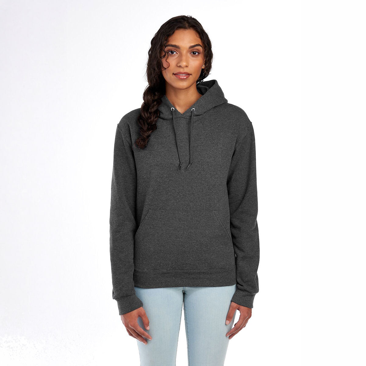 Woman wearing a Jerzees NuBlend® Unisex Hooded Sweatshirt in Black Heather against a white background.