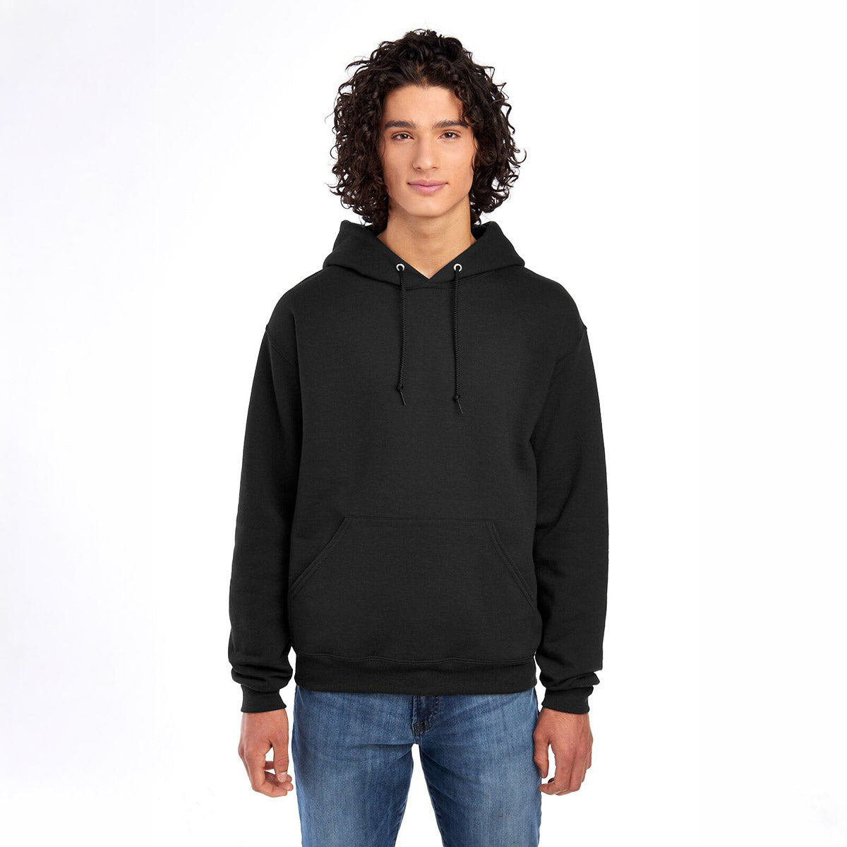 A young man with curly hair wearing a black Jerzees NuBlend® Unisex Hooded Sweatshirt against a white background.
