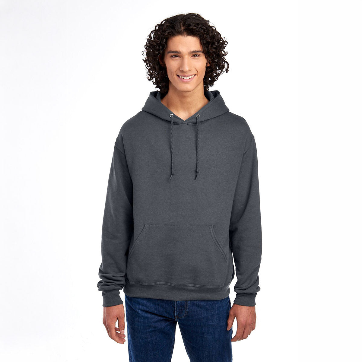 Young man with curly hair wearing a charcoal grey Jerzees NuBlend unisex hooded sweatshirt.