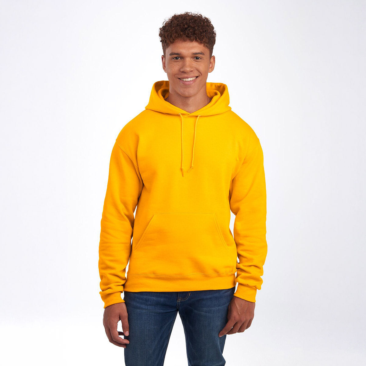 A man wearing a gold Jerzees NuBlend Unisex Hooded Sweatshirt against a plain white background.
