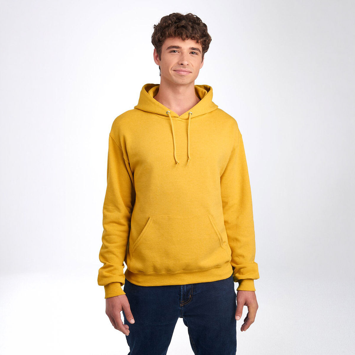 A man wearing a Jerzees NuBlend Unisex Hooded Sweatshirt in mustard heather against a white background.