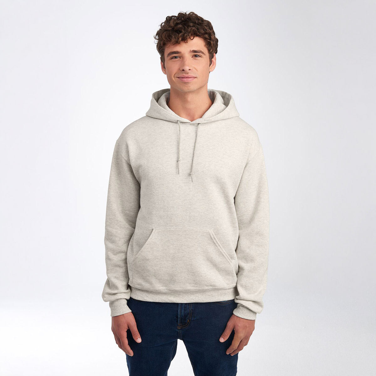 Model wearing a Jerzees NuBlend unisex hooded sweatshirt in oatmeal heather against a white background.