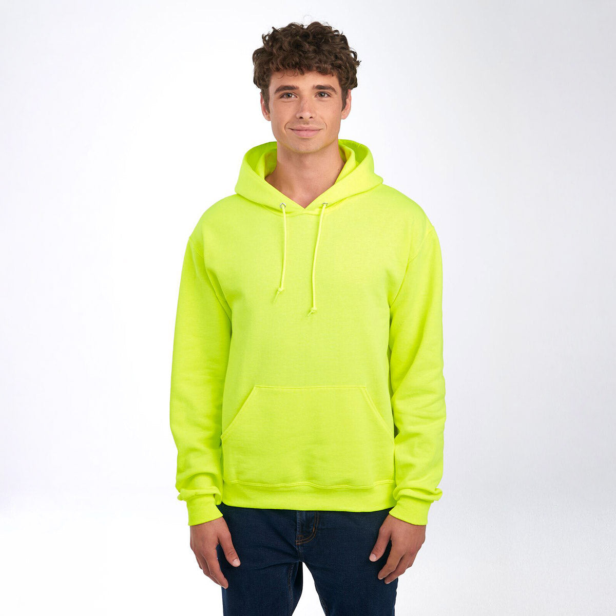 A man wearing a Jerzees NuBlend Unisex Hooded Sweatshirt in Safety Green.