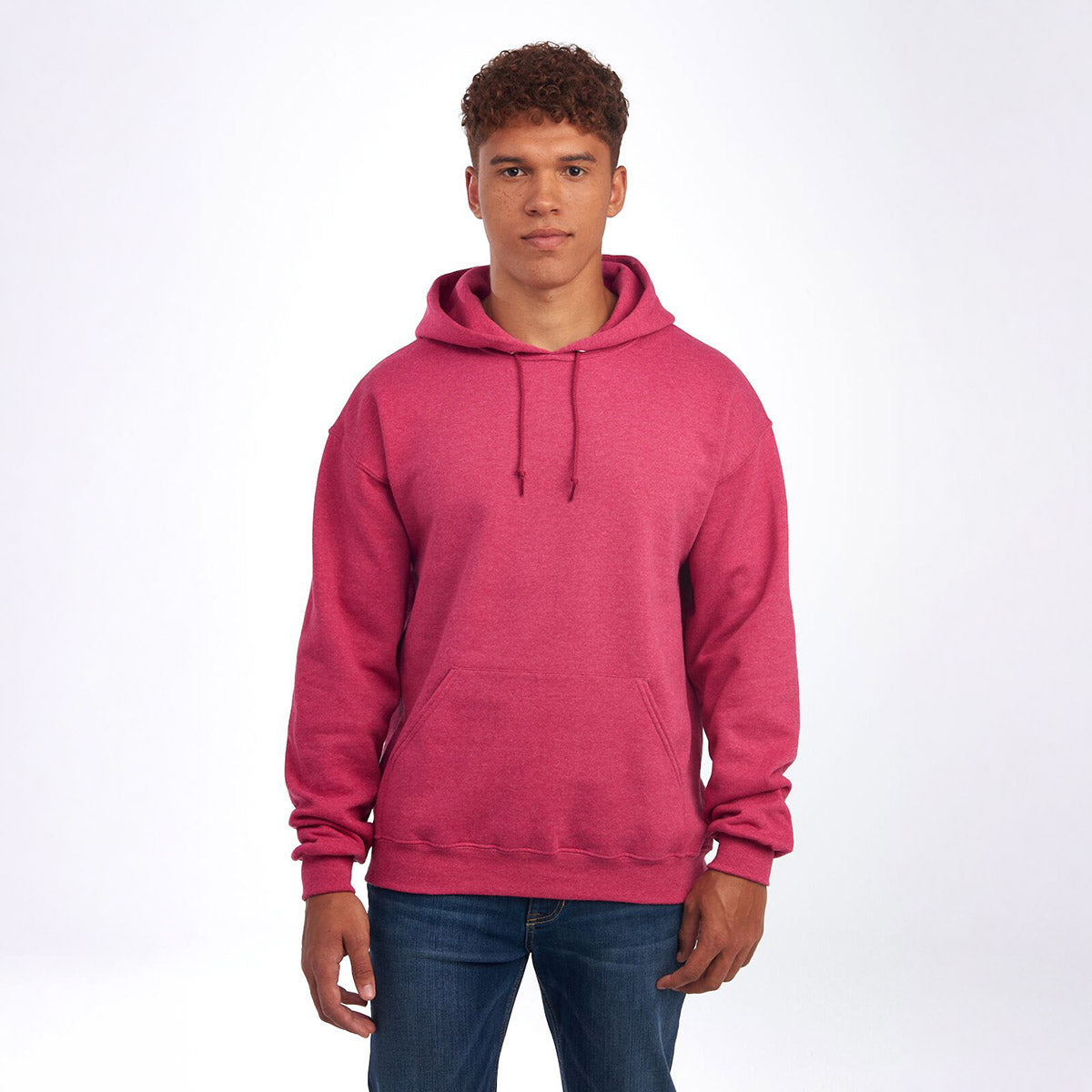 A man wearing a Jerzees NuBlend Unisex Hooded Sweatshirt in Vintage Heather Red.