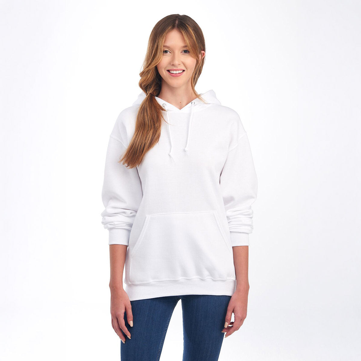 Smiling woman modeling a white Jerzees NuBlend® Unisex Hooded Sweatshirt against a plain background.