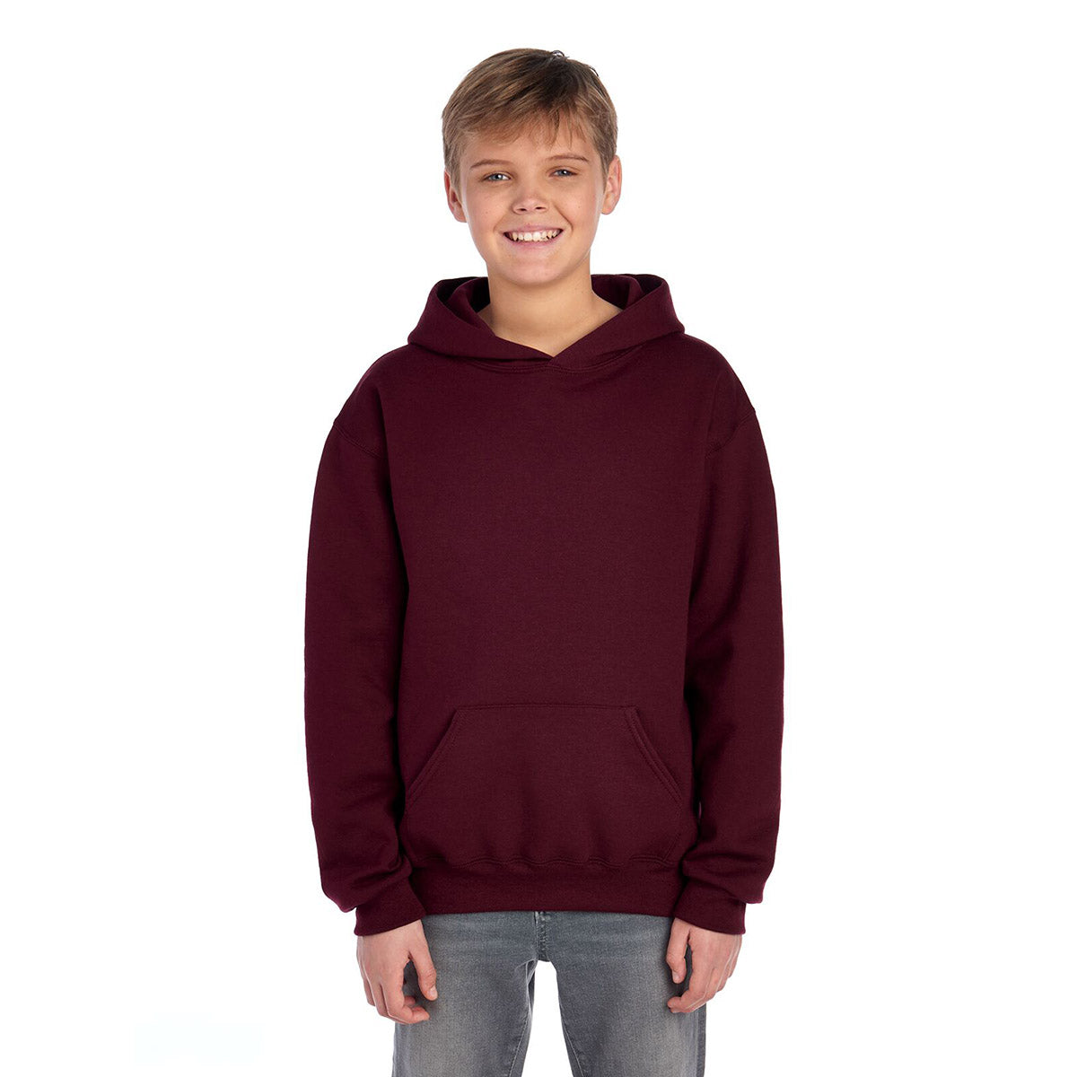 A young boy wears a Jerzees NuBlend Youth Hooded Sweatshirt in maroon.