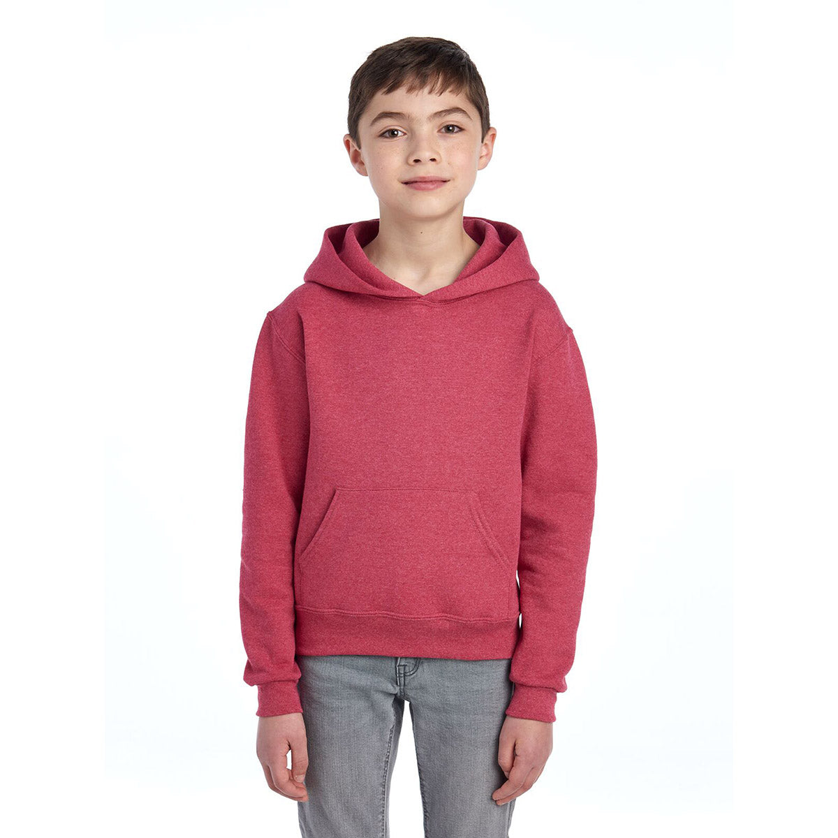 A young boy wearing a Jerzees NuBlend Youth Hooded Sweatshirt in Vintage Heather Red.
