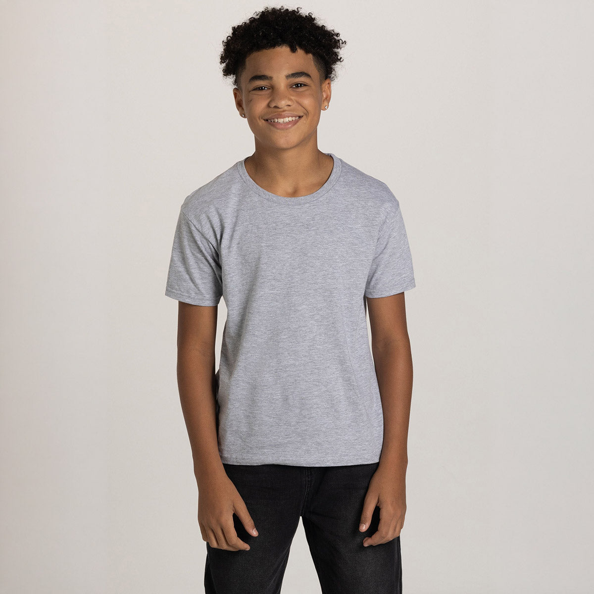 Youth model wearing a Jerzees Ultimate Ring-Spun T-Shirt in Athletic Heather.