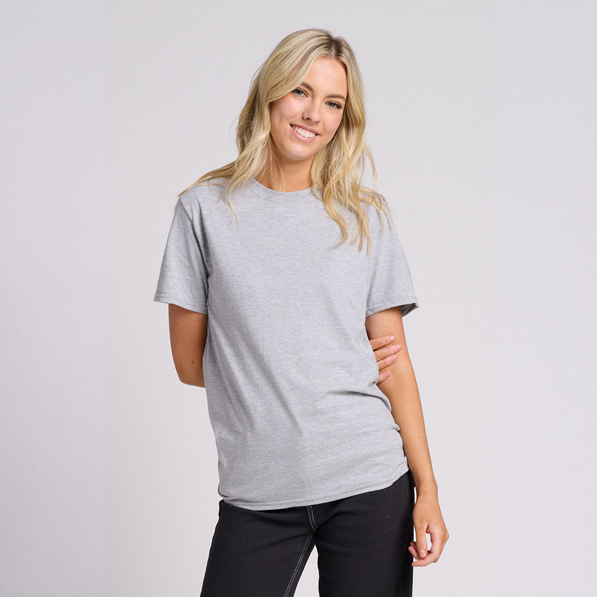 Blonde woman wearing a Jerzees Ultimate Ring-Spun Unisex T-Shirt in Athletic Heather.