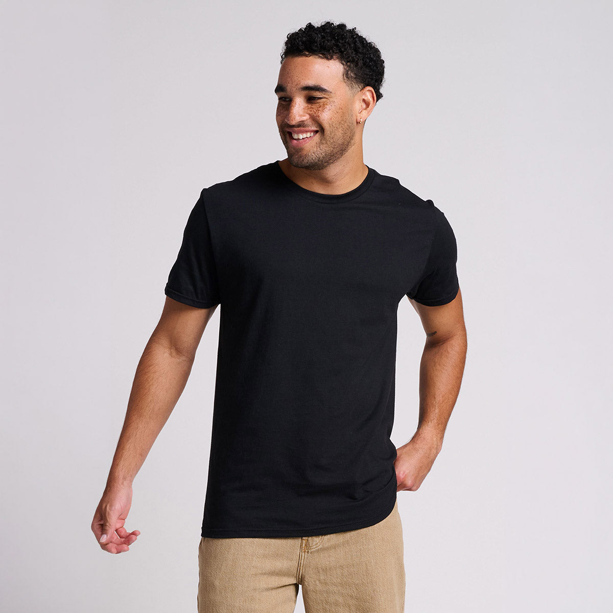 A man wearing a black Jerzees Ultimate Ring-Spun unisex T-shirt in black ink.