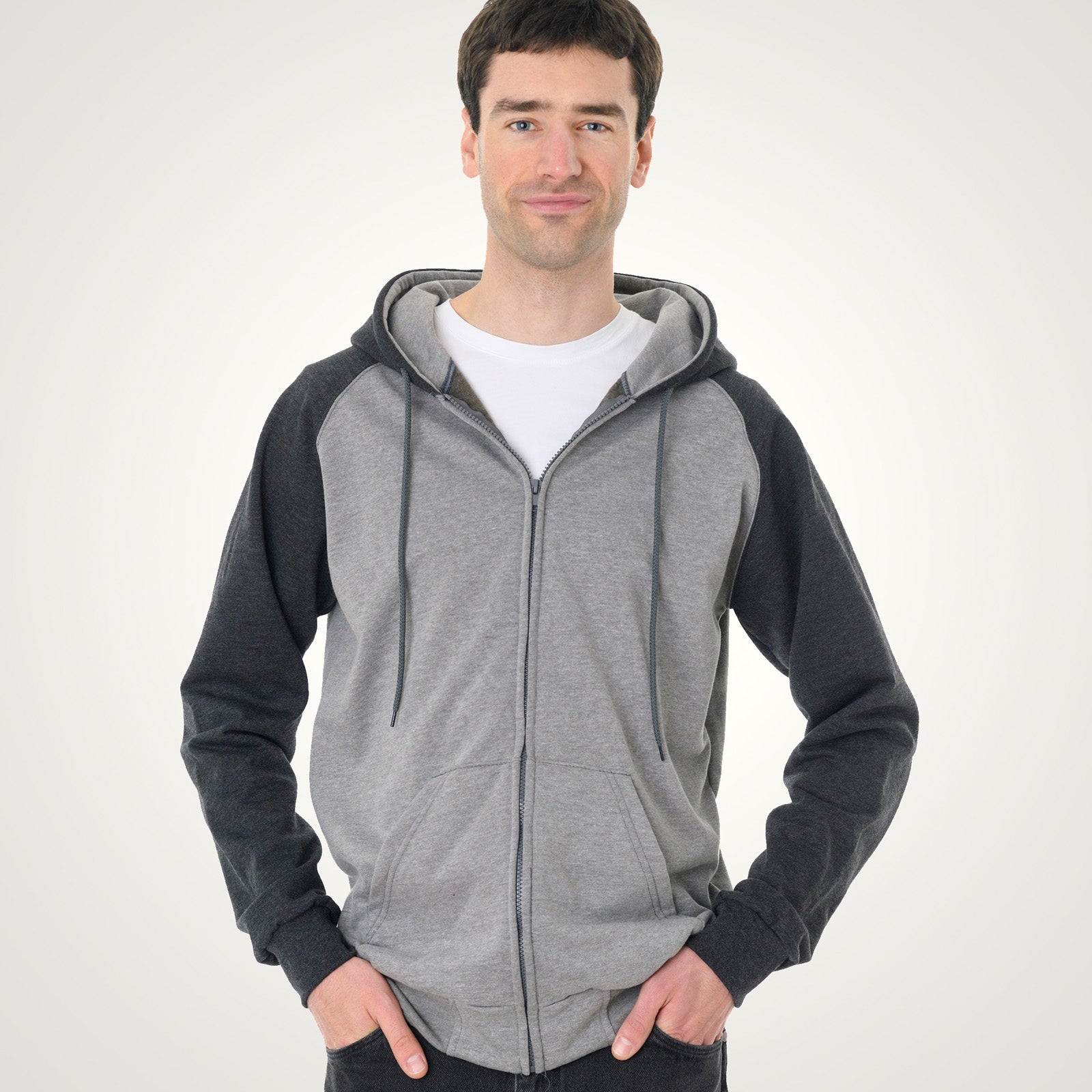 Man wearing a King Athletics Raglan Hooded Full-Zip Sweatshirt in grey heather and dark charcoal.