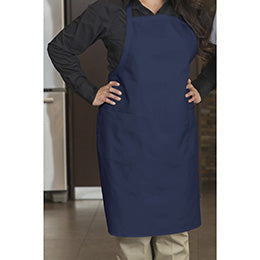 A person wearing a Premium Uniforms navy designer bib apron with front pockets.