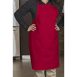 Person wearing a red Premium Uniforms Designer Bib Apron with pockets over a black shirt and tan pants.
