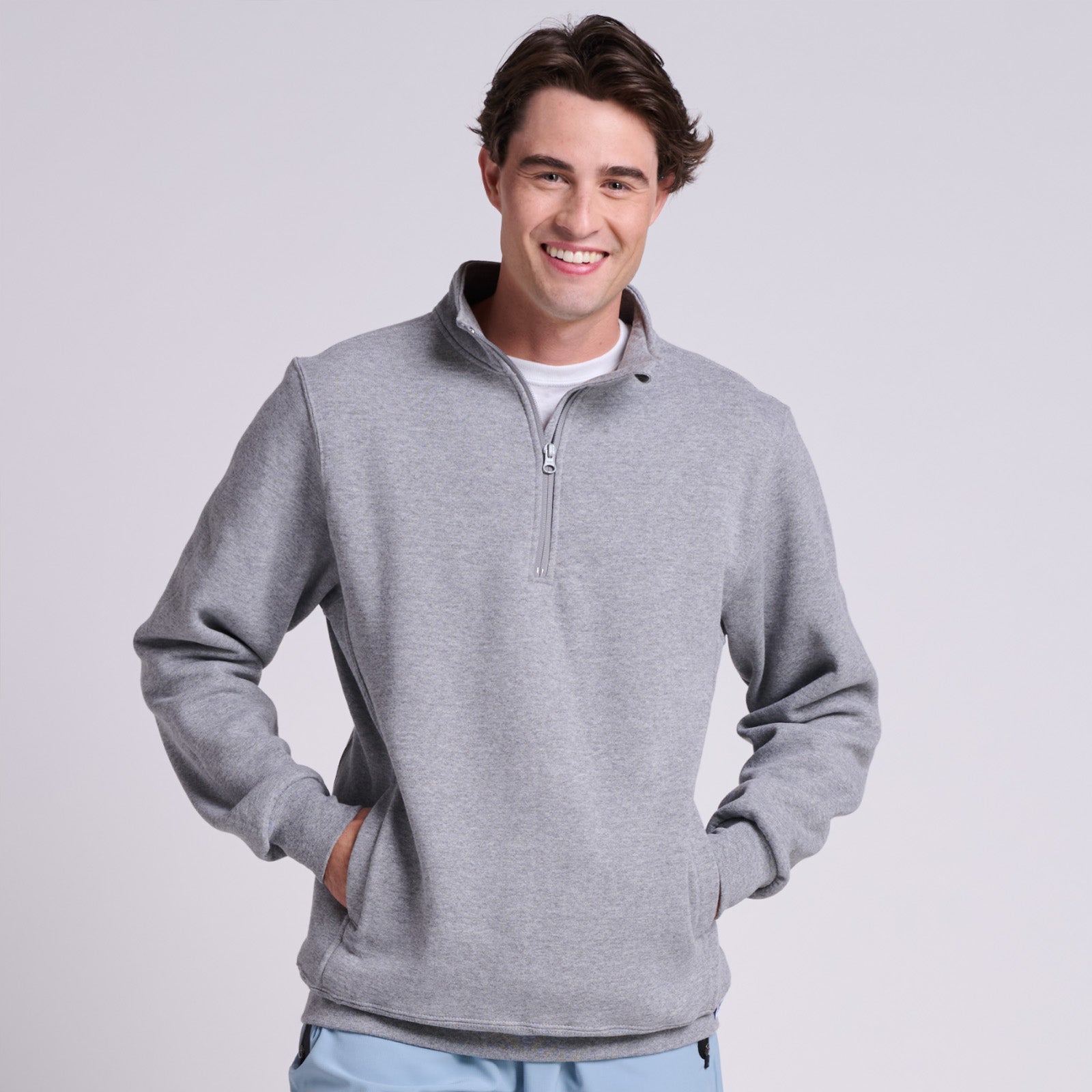 Model wearing a grey Russell Athletic DRI-POWER Fleece Quarter-Zip Cadet in Oxford.