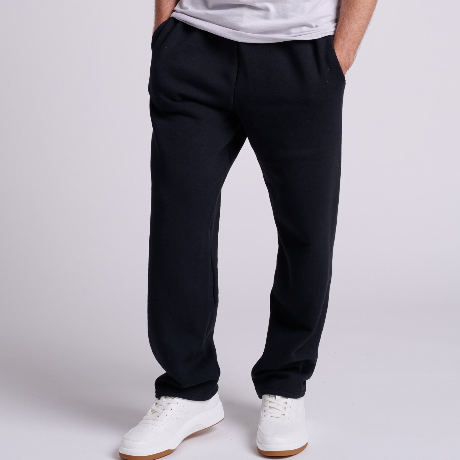 Russell Athletic DRI-POWER adult black open-bottom fleece sweatpants with pockets, shown on a model.