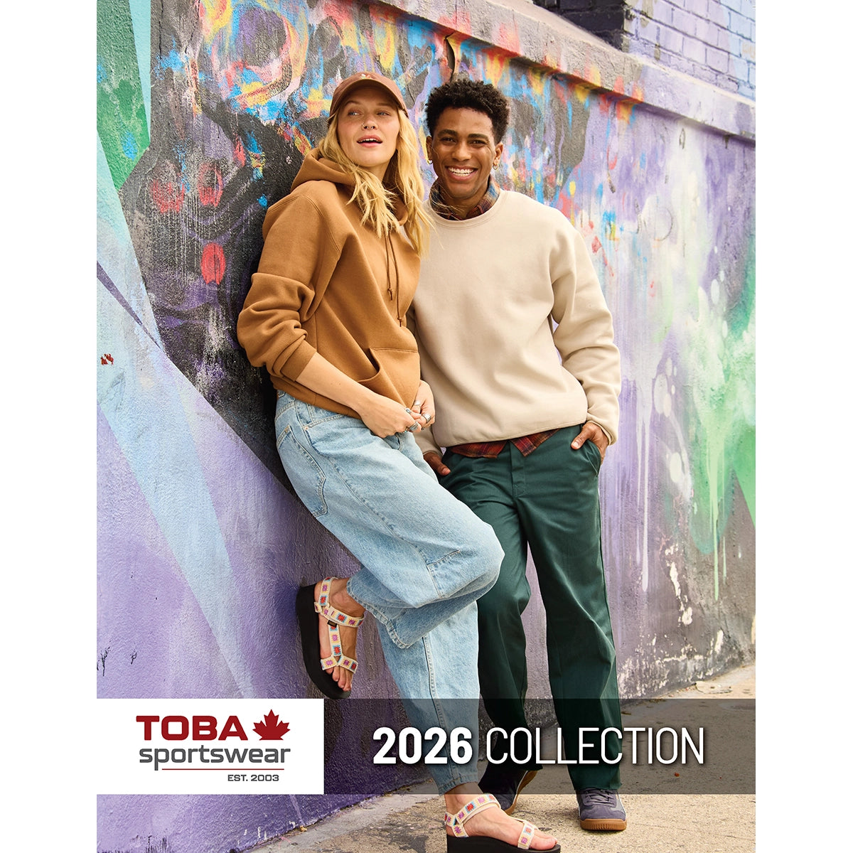 Toba Sportswear 2026 Collection catalogue cover featuring a man and woman wearing hoodies against a graffiti wall.